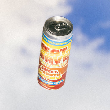 Can of 'Heat Wave' cold brew can against a blue sky background